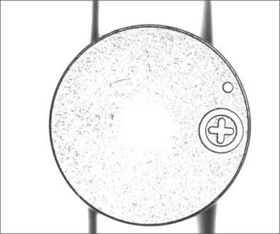 Source capture of a round buzzer face under a blue coaxial light: circled plus mark and a small hole near one edge. Complete capture, not retouched.