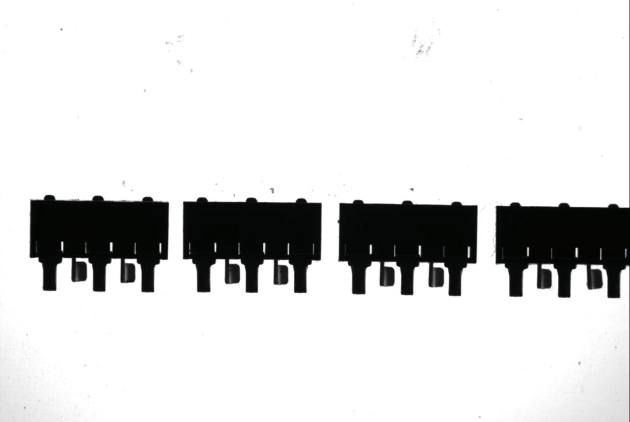 A row of connectors over a flat backlight (LS-TCL-2577): high contrast with an even background across the field.