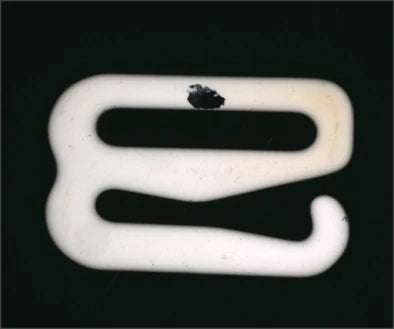 Source polarized-light capture: a dark irregular surface region is visible on the pale ceramic part.