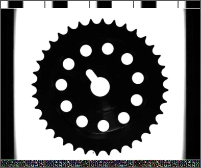 The source blue-backlight capture shows the gear tooth outline, central bore and surrounding holes.