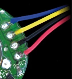 Reviewed crop of the source board: blue, yellow, black and red insulation is visible beside the attachment regions. Unrelated chip markings elsewhere on the board are excluded.