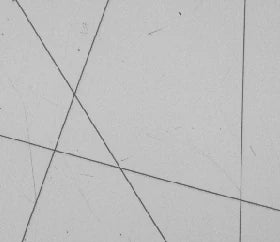 Real white-coaxial capture: several scratch lines are visible in the bright field.