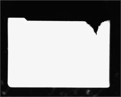 Source capture of a flat moulded shell under red coaxial light. The upper-right corner shows an irregular notch in the bright outline; the step at the upper left belongs to the moulded shape.