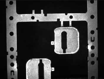 Source white-light capture: stamped faces are bright and openings dark.