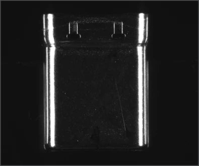 Source example A, labelled surface-scratch inspection: a reflective shell face has bright edges and faint surface lines.