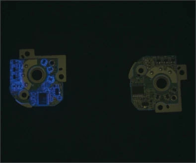 Source board example under a UV bar: blue material contrast is visible on one populated assembly.