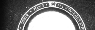 Original upper-rim capture under white narrow-angle coaxial light; generic material/pressure lettering is retained.